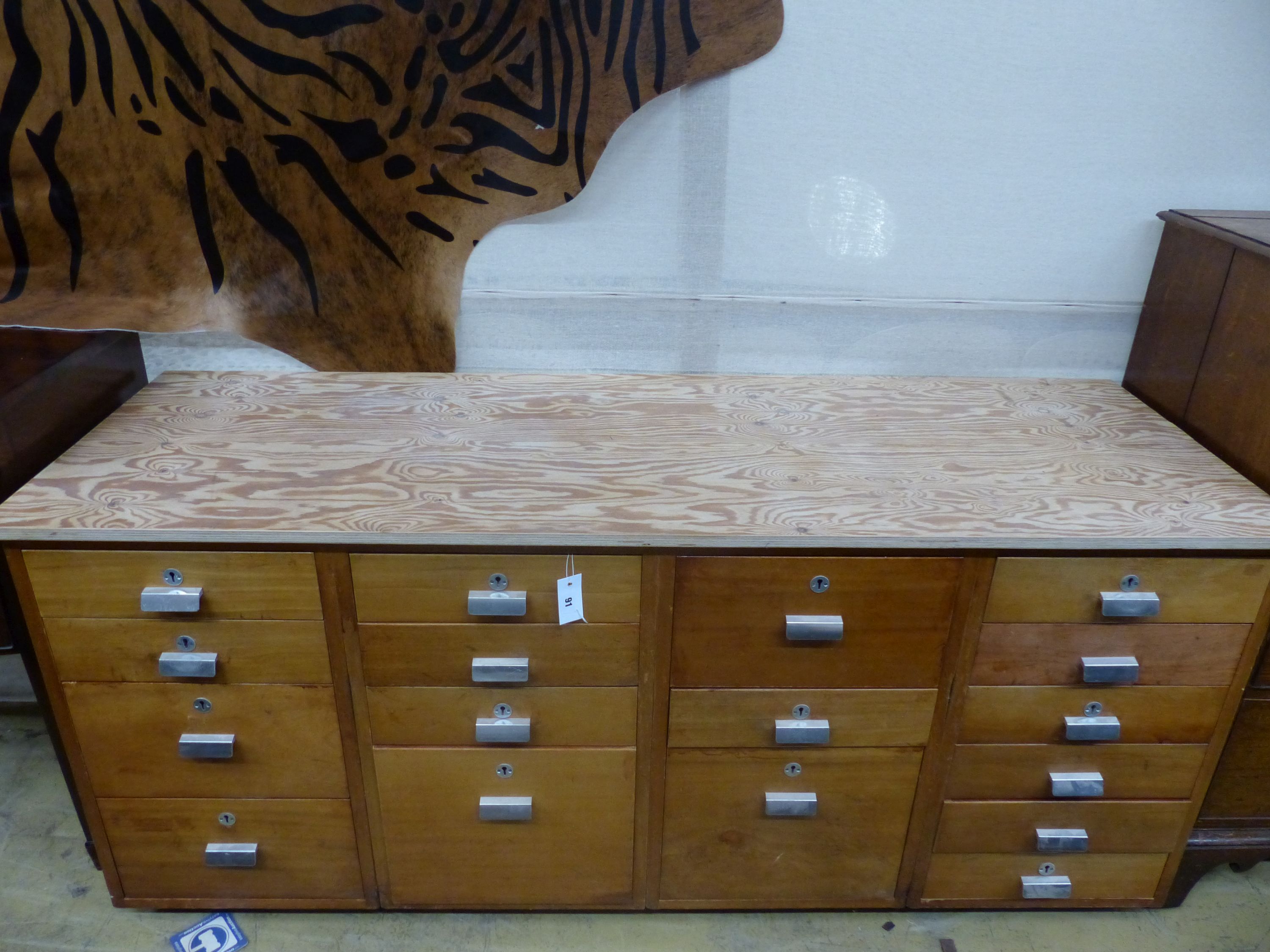 A mid century design 17 drawer teak habadashery cabinet with later top, width 174cm, depth 59cm, height 76cm